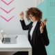 Happy woman sat at a desk