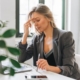 Woman sat at laptop looking sad after being ghosted after an interview