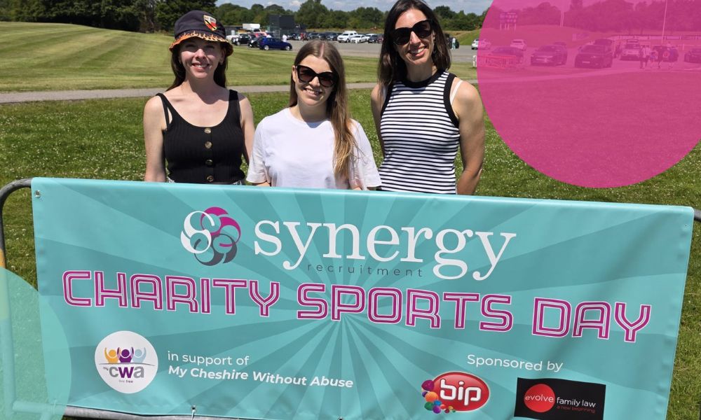 Team Synergy stood behind their Charity Sports Day banner