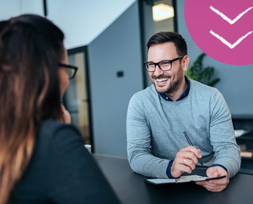 Man and woman sat opposite each other during a job interview
