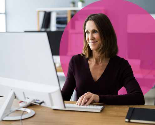 Administrator sat at a desk using a desktop