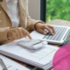 business owner reviewing recruitment costs on a laptop
